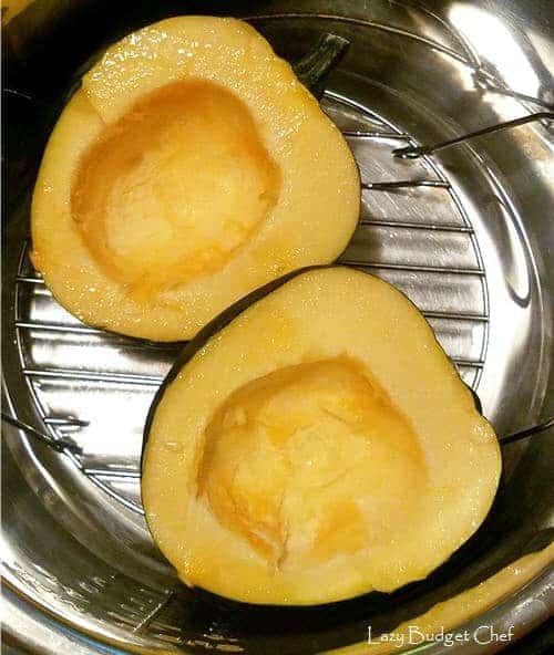 a halved acorn squash inside an instant pot