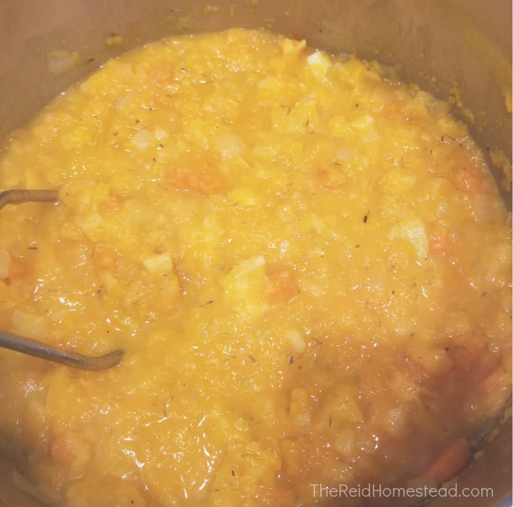 a large pot of mashed root vegetables and butternut squash