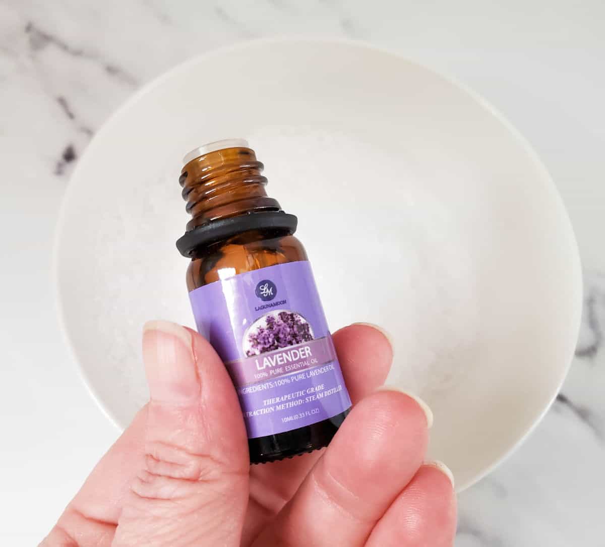 a close up of a bottle of lavender essential oil