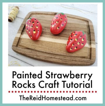 finished painted strawberry rocks on a cutting board, text overlay Painted Strawberry Rocks Craft Tutorial