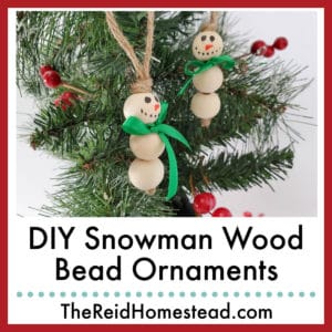 2 snowman wood bead ornaments hanging on a Christmas tree, text overlay DIY Snowman Wood Bead Ornaments