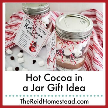 2 jars of hot cocoa mix decorated for gift giving, text overlay Hot Cocoa in a Jar Gift idea
