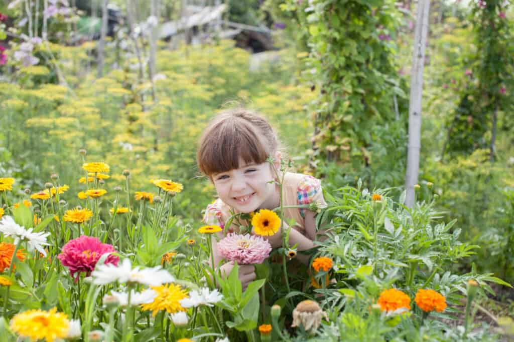 a young girl in a flower garden