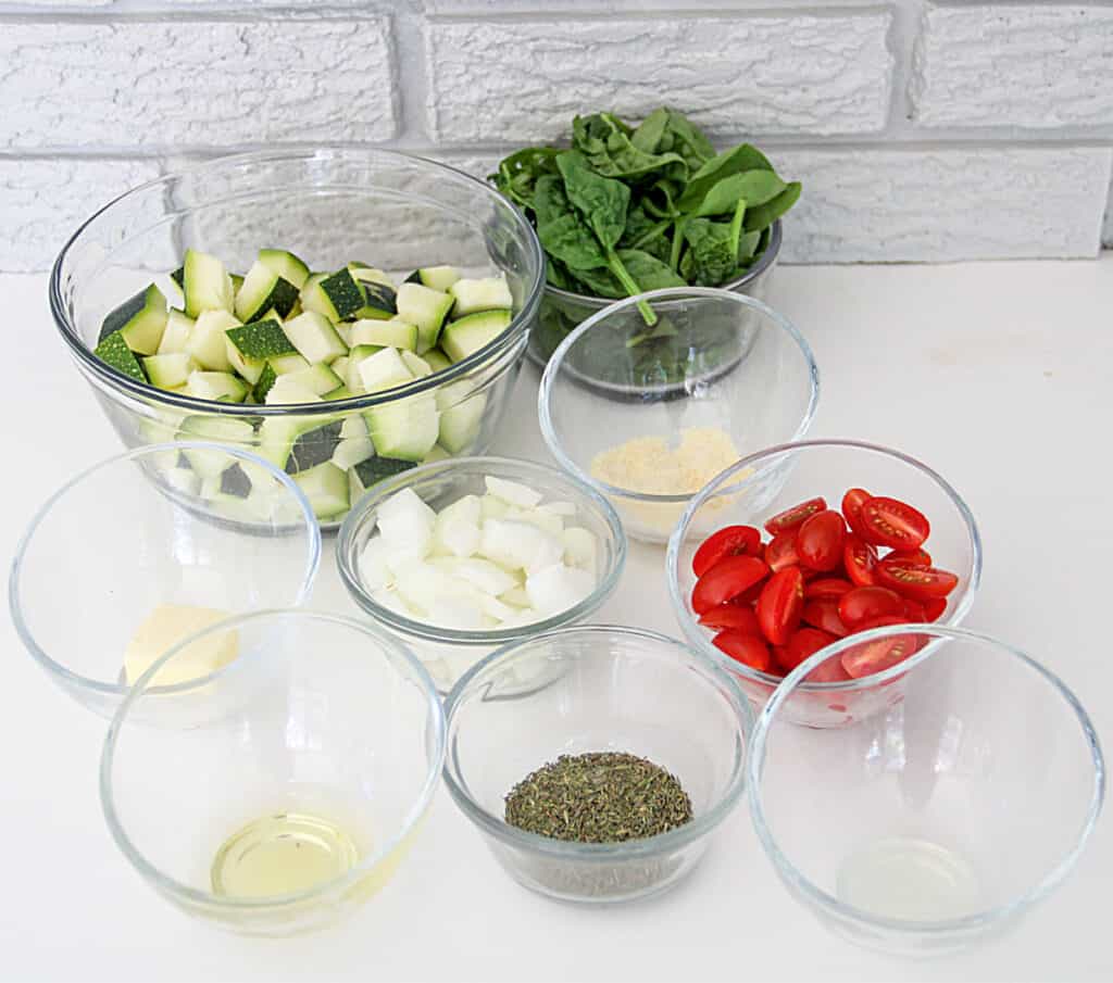 close up of a grouping of all of the ingredients needed for the sauteed zucchini and garden vegetables side dish recipe