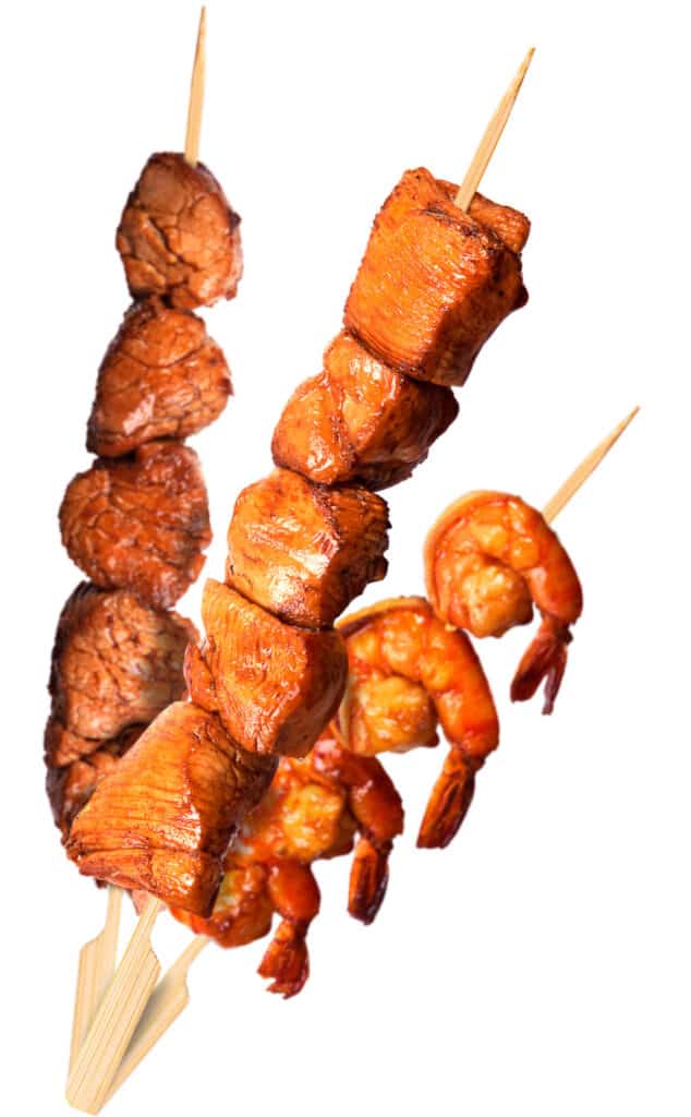 close up of assorted grilled meat skewers
