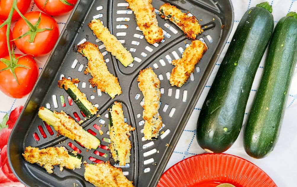 cooked air fryer parmesan zucchini fries on air fryer baking sheet