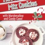 a plate with 3 cookies with a bite taken out of one of them, text overlay Hot Cocoa Cake Mix Cookies with Marshmallow and Candy Cane